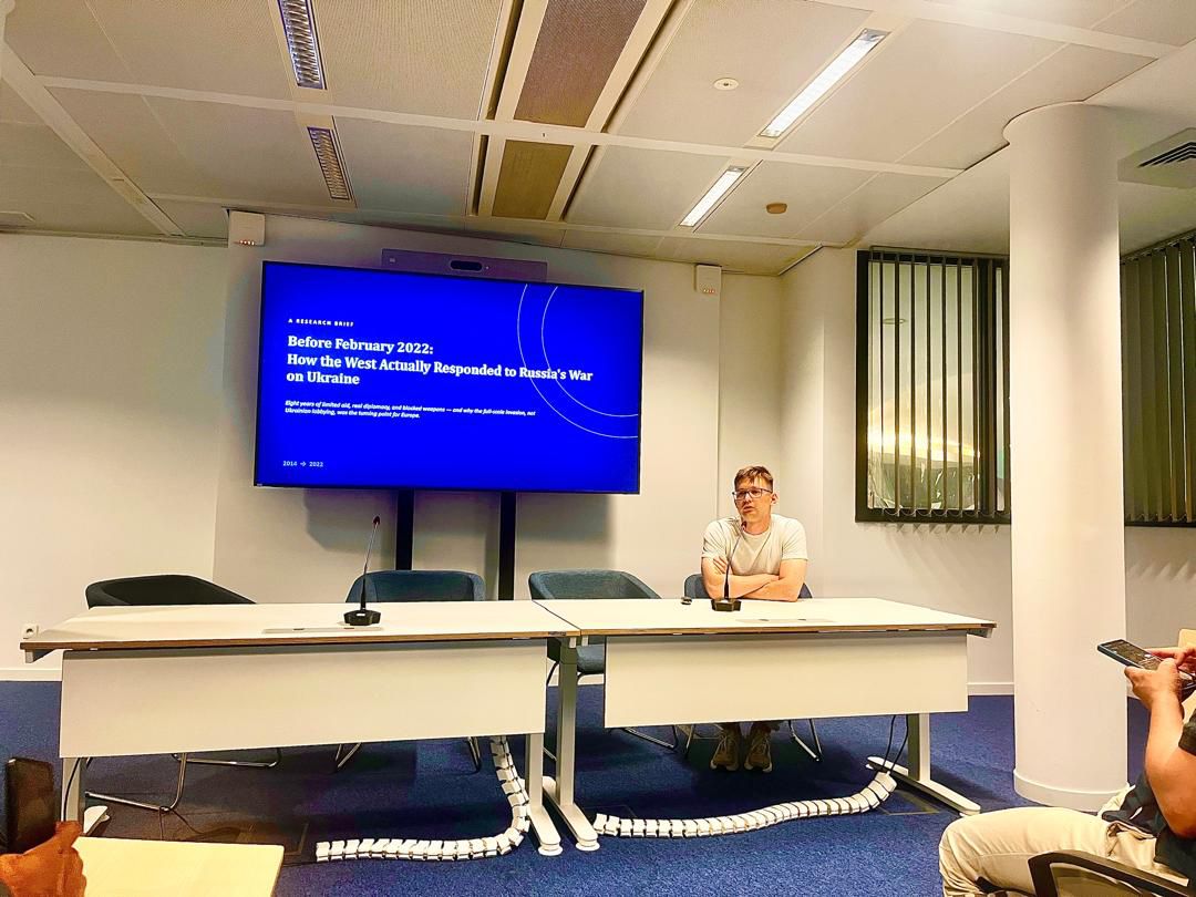 Vitaliy Syzov presenting the title slide 'Before February 2022: How the West Actually Responded to Russia's War on Ukraine'